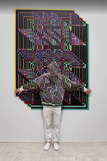 Finished geometric wall print with a person standing in front for scale.